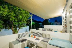 a balcony with a table and chairs and a view at Pico Bello Patmos 12 in Patmos