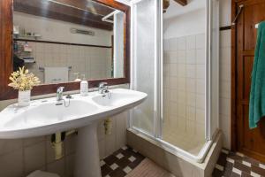 a bathroom with a sink and a shower at Ca'n Pont in El Port +33 photos