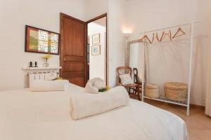 a bedroom with a large white bed and a mirror at Can Garí in Sóller +35 photos
