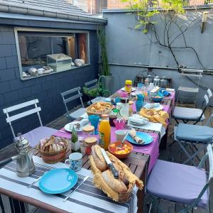 a table with food and drinks on a patio at La Musicale in Rouen