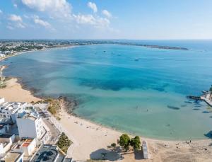 an aerial view of a beach with people in the water at Rossini 14 Centro e Mare a Piedi in Porto Cesareo