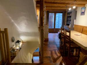 a kitchen with a table and a dining room at Chambre d'hôte Chalet le Persan in Courchevel +7 photos
