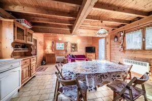 a kitchen and dining room with a table and chairs at Chalet 6p Classique - Les Biches in Verchaix