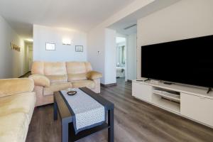 a living room with a large flat screen tv at Apartment Acapulco 6 in Fuengirola
