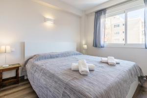 a bedroom with a bed with two towels on it at Apartment Acapulco 6 in Fuengirola +14 photos