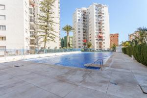 a swimming pool in the middle of some buildings at Apartment Acapulco 6 in Fuengirola