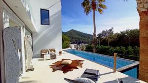 a villa with a swimming pool and a resort at Villa La Vida in Cala Llonga