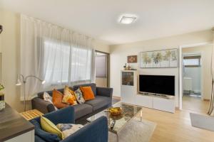 a living room with a couch and a tv at Eucalipto-Sun guaranteed-pool wifi in Puerto Rico de Gran Canaria