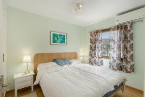 a bedroom with a bed and a window at Eucalipto-Sun guaranteed-pool wifi in Puerto Rico de Gran Canaria +18 photos