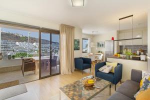 a living room with a couch and a table at Eucalipto-Sun guaranteed-pool wifi in Puerto Rico de Gran Canaria
