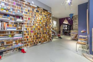a room with a large wall of books at Kel Domènech Luxury Apartment in Besalú +16 photos