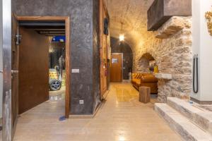 a hallway with a door and a couch in a room at Kel Domènech Luxury Apartment in Besalú