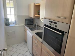a kitchen with a sink and a stove at Apartment im Scheffelhaus in Gengenbach