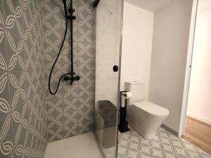 a bathroom with a toilet and a shower stall at Primera linea Sant Antoni Calonge in Sant Antoni de Calonge +14 photos
