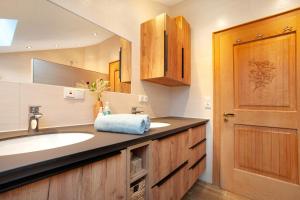 a bathroom with a sink and a mirror at Ferienwohnung Caprano in Sonthofen +22 photos