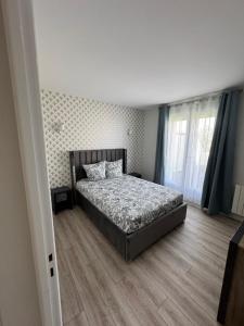 a bedroom with a bed and a wooden floor at Appart 2 morangis in Morangis