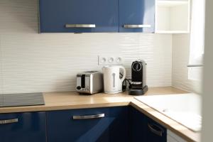a kitchen with a counter top with a toaster at Appart 2 morangis in Morangis