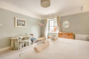 a bedroom with a bed and a chair and a window at 2 Bed in Appledore oc-cosyn in Appledore