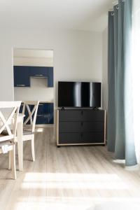 a living room with a tv on a dresser at Appart 2 morangis in Morangis