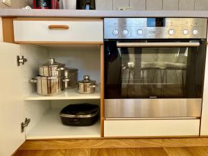 a kitchen with a stove and some pots and pans at Relax Holidays in Rheinheim