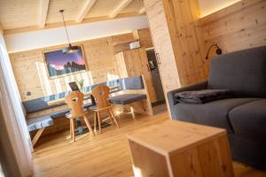 a living room with a couch and a table and chairs at Metzgermayr in Villabassa