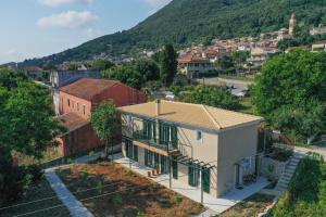 a small house with a mountain in the background at Redon Marias House 1 in Ágios Matthaíos +8 photos