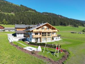 a large house in a field with a playground at Metzgermayr in Villabassa