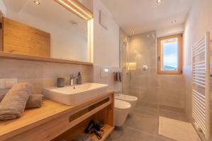 a bathroom with a sink and a toilet and a shower at Metzgermayr in Villabassa +58 photos