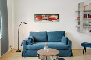 a blue couch in a living room with a table at Ferienwohnung Spree - Oase in Spremberg