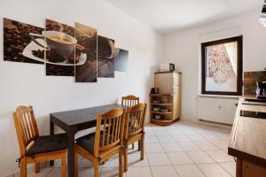 a kitchen with a table and chairs and a refrigerator at Ferienwohnung Spree - Oase in Spremberg