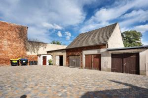 a brick building with two garage doors on it at Ferienwohnung Spree - Oase in Spremberg