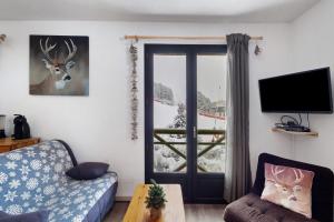 a living room with a door with a deer on the wall at Chalet Pla Del Mir in Les Angles
