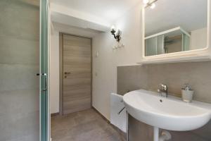 a bathroom with a sink and a mirror at Luéisch Ketschu near Gressoney in Issime +39 photos