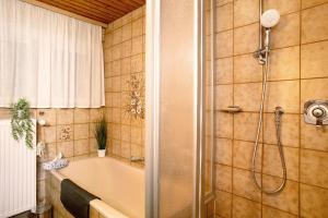 a bathroom with a bath tub and a shower at Ferienwohnungen Michael u Christine in Langenargen +54 photos