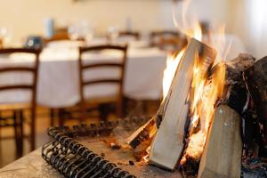 a fire is burning on a table with chairs at Agriturismo Marzanino in Torre di Mosto