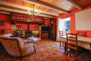 a living room with red walls and a piano at Chambre Breizh in Cast