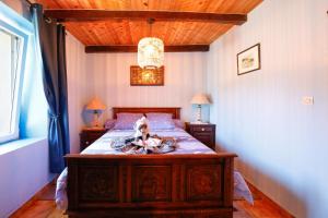 a bedroom with a bed with a doll on it at Chambre Breizh in Cast