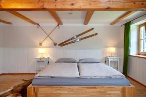 a large bed in a room with two tables at Alpenchalet Pfronten in Pfronten