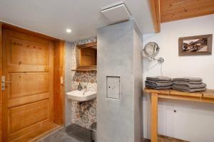 a bathroom with a sink and a toilet and a door at Alpenchalet Pfronten in Pfronten +13 photos