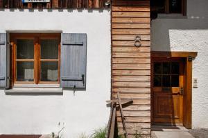 a building with a wooden door and a window at Alpenchalet Pfronten in Pfronten