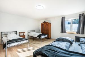 a room with three beds and a window at Ferien- Monteurwohnung in Nürnberg in Nuremberg
