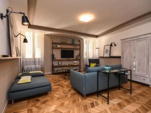 a living room with a couch and a table at Modern Central Apartment in Salò