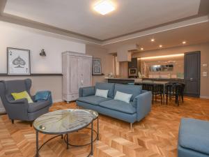 a living room with a couch and chairs and a table at Modern Central Apartment in Salò