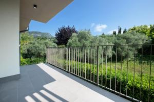 a view from the balcony of a house with a fence at Residence Eleonora in Garda