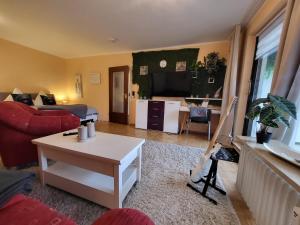 a living room with a couch and a table at Ferienwohnung Kleine Bergluft Hahnenklee in Hahnenklee-Bockswiese