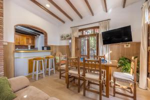 a kitchen and living room with a table and chairs at El Amanecer in Motril