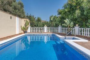 a swimming pool next to a white fence at El Amanecer in Motril