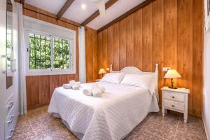 a bedroom with a bed with two towels on it at El Amanecer in Motril +22 photos