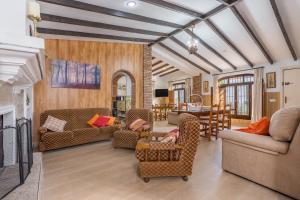 a living room with couches and chairs and a table at El Amanecer in Motril