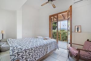 a bedroom with a bed and a sliding glass door at Villa Sugar Town in Zacharo